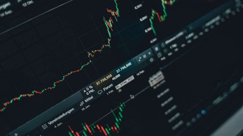 Financial charts side by side on a laptop screen
